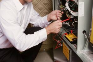 A technician fixing a water heater.