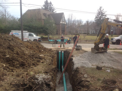 Sal's plumbers repairing a sewer line in a customer's front yard.